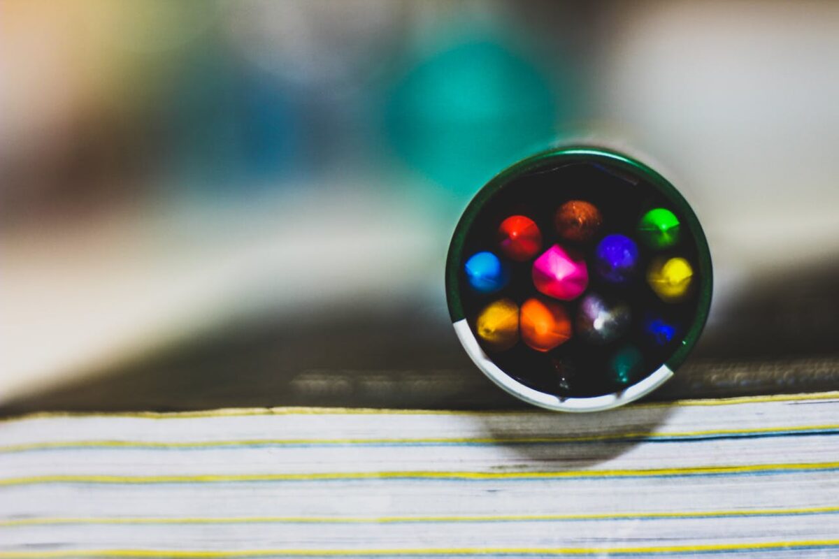 Close-up image of colorful pencils in a case, focusing on vibrant colors and blurred background.
