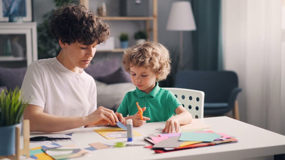 Mother and young child crafting together indoors, fostering creativity and bonding.